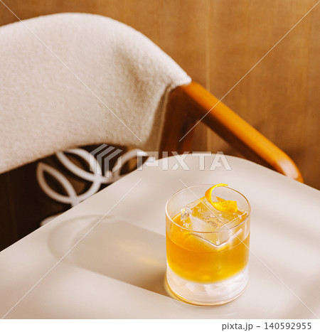Old fashioned cocktail with orange peel on table Old fashioned cocktail with orange peel on table 140592955