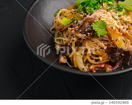Asian stir-fried noodles with duck, wood ear mushrooms, and sesame seeds Asian stir-fried noodles with duck, wood ear mushrooms, and sesame seeds 140592960