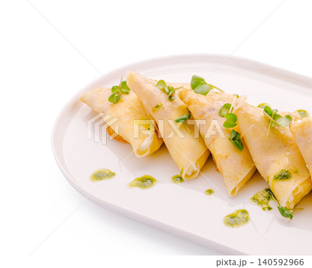 Crepes with cream cheese and pesto sauce on white plate 140592966