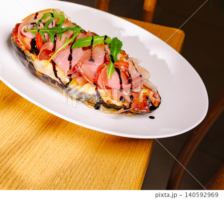 Stuffed eggplant with prosciutto, arugula, and balsamic glaze Stuffed eggplant with prosciutto, arugula, and balsamic glaze 140592969