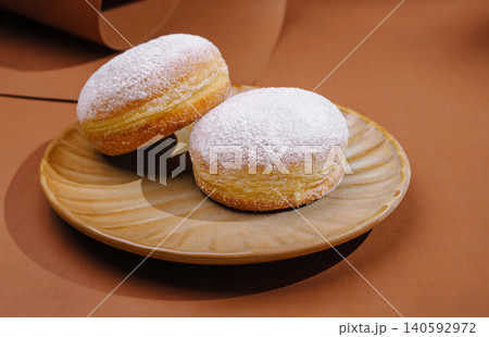 Powdered sugar donuts presenting sweet pastry dessert Powdered sugar donuts presenting sweet pastry dessert 140592972