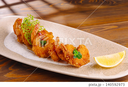 Fried shrimp tempura serving with sauce and lemon Fried shrimp tempura serving with sauce and lemon 140592973