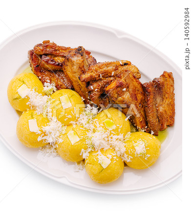 Roasted pork ribs with mamaliga balls and cheese Roasted pork ribs with mamaliga balls and cheese 140592984