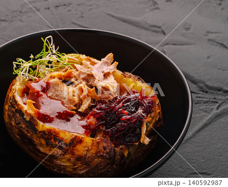 Baked potato with pulled pork and caramelized onions Baked potato with pulled pork and caramelized onions 140592987