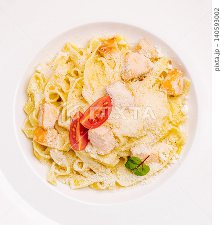 Creamy salmon fettuccine pasta with parmesan and tomato Creamy salmon fettuccine pasta with parmesan and tomato 140593002