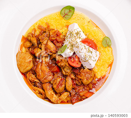 Chicken stew with polenta, feta cheese and tomatoes 140593003
