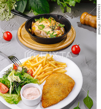 Chicken schnitzel with french fries and salad 140593021