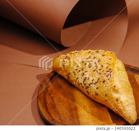 Puff pastry samsa turnover on wooden plate Puff pastry samsa turnover on wooden plate 140593022