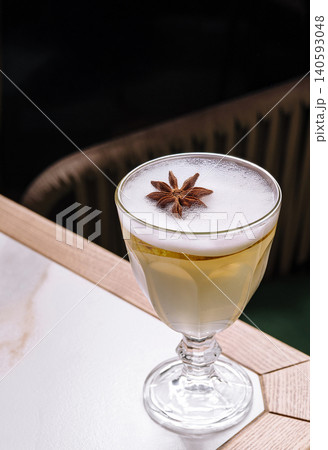 Elegant sour cocktail garnished with star anise Elegant sour cocktail garnished with star anise 140593048