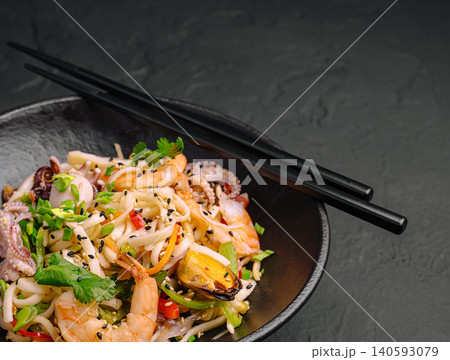 Shrimp and vegetable noodle dish served with chopsticks Shrimp and vegetable noodle dish served with chopsticks 140593079