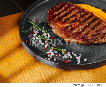 Grilled ribeye beef steak with sweet puree Grilled ribeye beef steak with sweet puree 140593083