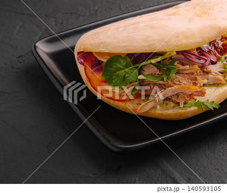 Gourmet pulled pork pita sandwich with vegetables Gourmet pulled pork pita sandwich with vegetables 140593105