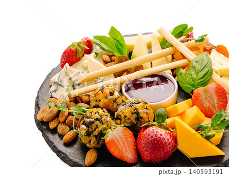 Assorted cheeses strawberries almonds and savory bites Assorted cheeses strawberries almonds and savory bites 140593191