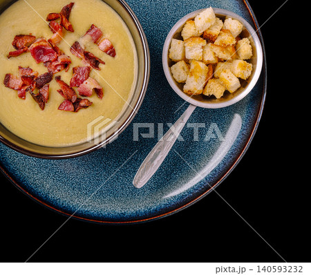 Creamy potato leek soup with crispy bacon 140593232