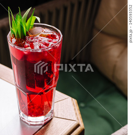 Pomegranate cocktail with ice and green leaves Pomegranate cocktail with ice and green leaves 140593352