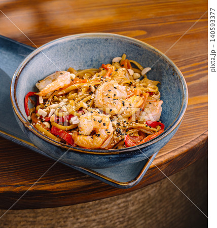 Shrimp stir fry with noodles and vegetables served in a bowl Shrimp stir fry with noodles and vegetables served in a bowl 140593377