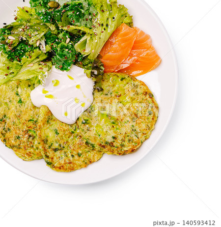 Zucchini fritters served with salted salmon slices Zucchini fritters served with salted salmon slices 140593412