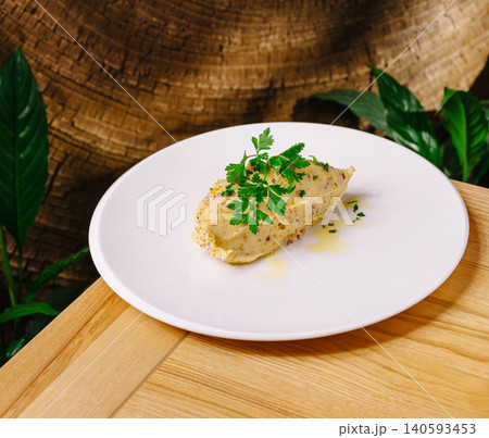 Gourmet Hummus Quenelle With Fresh Parsley Garnish Gourmet Hummus Quenelle With Fresh Parsley Garnish 140593453