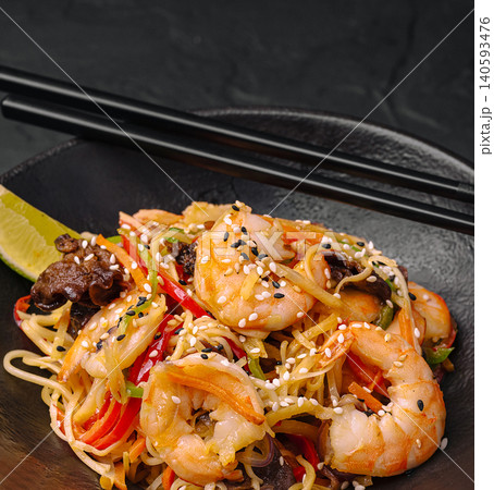 Asian Wok Noodles With King Shrimps And Vegetables 140593476