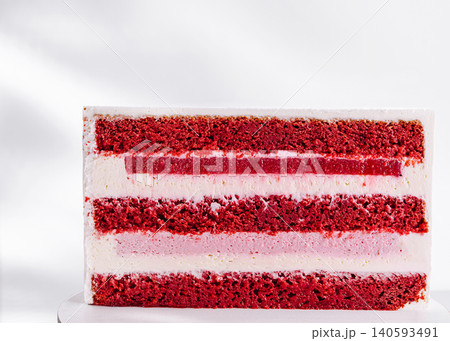 Red velvet cake with layers of cream and frosting in a simple setting Red velvet cake with layers of cream and frosting in a simple setting 140593491