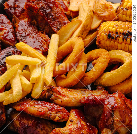 Gourmet BBQ Platter With Ribs Chicken Wings And Fries Gourmet BBQ Platter With Ribs Chicken Wings And Fries 140593534