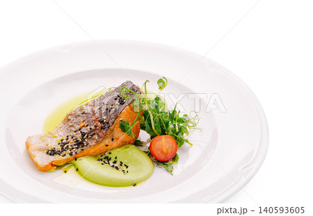 Delicious salmon with fresh salad on a white plate in a restaurant setting 140593605