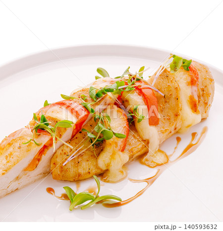 Grilled chicken dish served with fresh herbs and sauce on a white plate Grilled chicken dish served with fresh herbs and sauce on a white plate 140593632