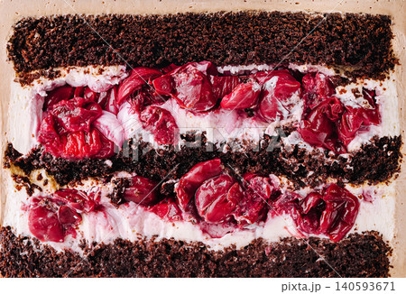 Chocolate cake layered with cherries and cream in dessert dish Chocolate cake layered with cherries and cream in dessert dish 140593671