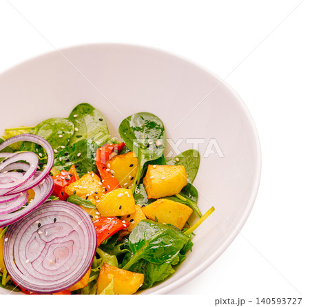 Fresh salad with spinach, mango, peppers, and onions on a white background Fresh salad with spinach, mango, peppers, and onions on a white background 140593727