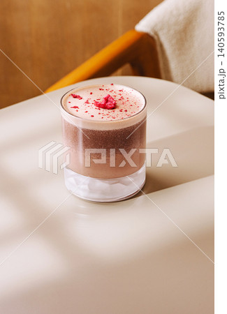 Layered Coffee Cocktail With Berry Pieces On Table 140593785