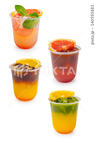 Drinks served in clear cups with colorful layers and fruit garnishes 140593881