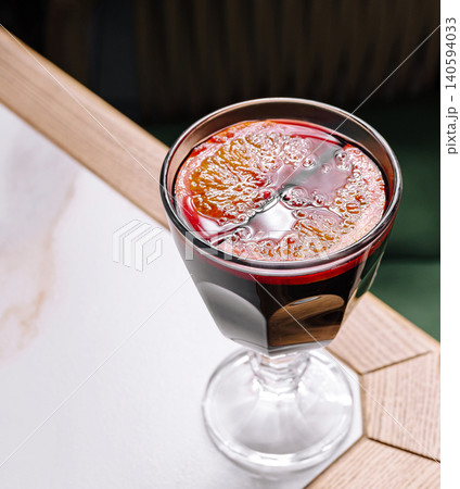 Fresh drink in a glass sitting on a table at a cafe during the afternoon Fresh drink in a glass sitting on a table at a cafe during the afternoon 140594033