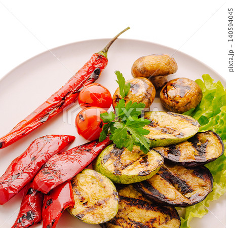 Grilled vegetables on a plate with fresh herbs, tomatoes, and chili peppers Grilled vegetables on a plate with fresh herbs, tomatoes, and chili peppers 140594045