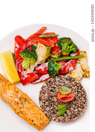 Grilled salmon and quinoa with mixed vegetables on a white plate 140594080