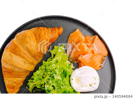 Breakfast plate with croissant, smoked salmon, salad, and poached egg Breakfast plate with croissant, smoked salmon, salad, and poached egg 140594084