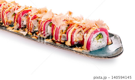 Delicious sushi rolls served on a long plate at a restaurant Delicious sushi rolls served on a long plate at a restaurant 140594145