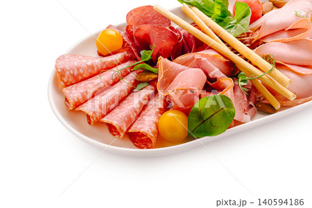 Charcuterie platter with various meats and fresh greens 140594186