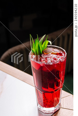 Refreshing drink sits on a table in a cozy setting during evening hours Refreshing drink sits on a table in a cozy setting during evening hours 140594210