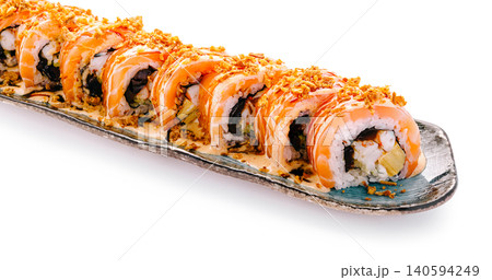 Freshly prepared sushi rolls with salmon and crispy toppings on a plate Freshly prepared sushi rolls with salmon and crispy toppings on a plate 140594249