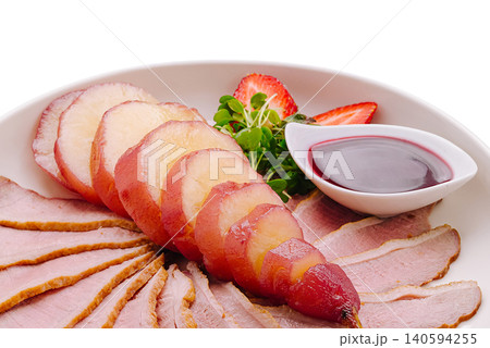 Delicious platter of sliced meat and fruit served in a round dish Delicious platter of sliced meat and fruit served in a round dish 140594255