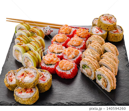 Different types of sushi arranged on a black platter served with chopsticks Different types of sushi arranged on a black platter served with chopsticks 140594260