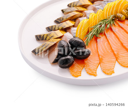 Seafood platter with smoked fish and olives served on a round white plate Seafood platter with smoked fish and olives served on a round white plate 140594266