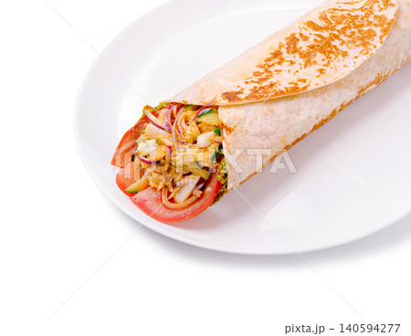 Fresh wrap with vegetables and protein served on a white plate during lunchtime Fresh wrap with vegetables and protein served on a white plate during lunchtime 140594277
