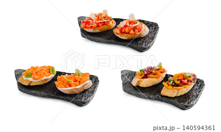 Three different types of bruschetta served on dark stone plates 140594361