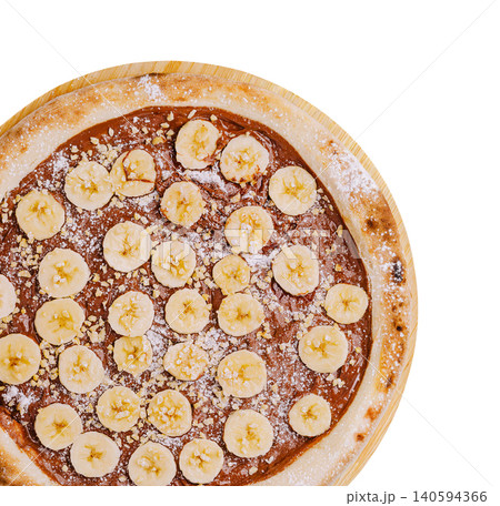 Banana dessert pizza served on a wooden board with chocolate spread Banana dessert pizza served on a wooden board with chocolate spread 140594366