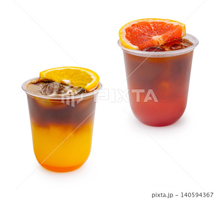 Cold drinks in clear cups with ice and fruit slices on a white background Cold drinks in clear cups with ice and fruit slices on a white background 140594367