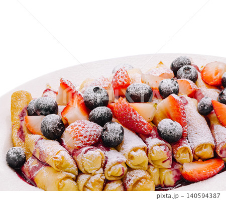 Fresh crepes filled with berries and topped with powdered sugar at breakfast Fresh crepes filled with berries and topped with powdered sugar at breakfast 140594387