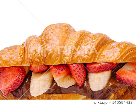 Croissant filled with chocolate, strawberries, and bananas on a white background 140594432