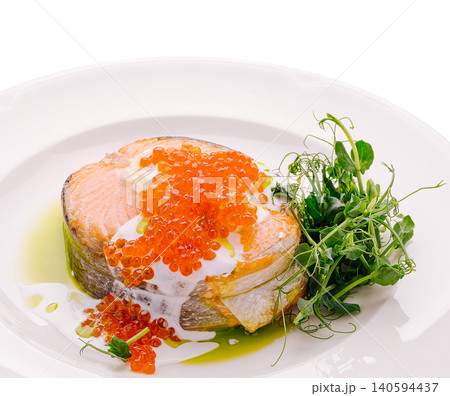 Salmon dish served with green peas and fish roe on a white plate Salmon dish served with green peas and fish roe on a white plate 140594437
