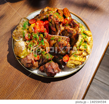 Grilled meat and vegetables served on a plate at a restaurant in the afternoon Grilled meat and vegetables served on a plate at a restaurant in the afternoon 140594594